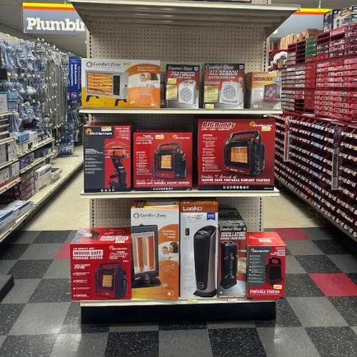 Various portable heaters from brands like Mr. Heater and Comfort Zone, displayed on a shelf in-store. Designed to provide efficient heating for small to medium-sized spaces.